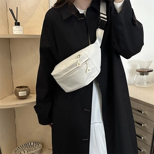 White checkered crossbody sling bag with triangular zipper and wide black strap