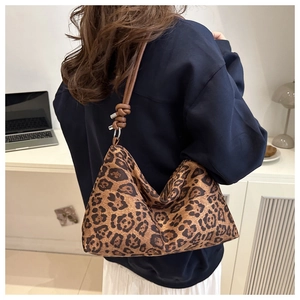 Detail of leopard print hobo bag showing tied leather shoulder strap and large capacity