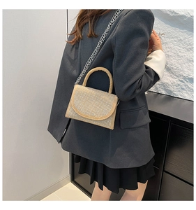 Chic beige mini crossbody bag with silver rhinestones and chain strap on a model
