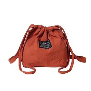 Minimalist orange drawstring bucket bag with fashion text label and large capacity
