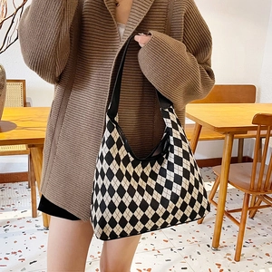 Chic black and white checkered knit tote bag with black shoulder straps for daily use