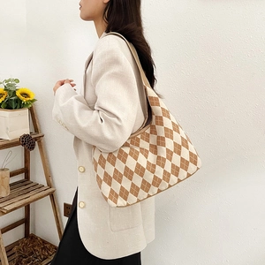 Retro argyle tote bag in brown and white canvas styled with a casual blazer