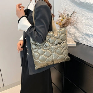 Metallic quilted tote bag in light olive gold with dual front pockets for daily commute