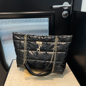 Quilted down tote bag in black with gold chain strap and deer pendant detail