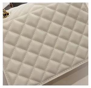 Close-up of classic quilted pattern and fine stitching on a white leather shoulder bag