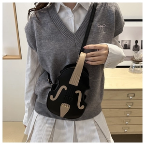 Detail shot of a violin-shaped crossbody bag featuring creative musical instrument design