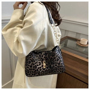 Close-up of leopard print shoulder bag with gold chain strap and metallic lock buckle