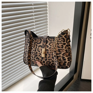Detail of leopard print shoulder bag with gold metal buckle and chain decoration
