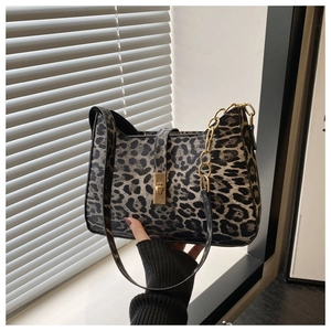 Detail of leopard print handbag with metallic gold twist lock and chain strap