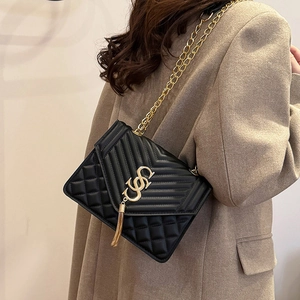 Chic black quilted crossbody bag with gold chain strap and elegant tassel detail