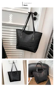 Close-up of black quilted tote bag with golden stud details and large capacity interior