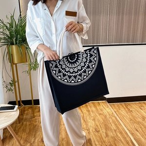 Detail of bohemian tote bag with geometric print and thick braided cotton rope handles