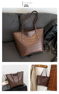Detail of dark brown woven tote bag with large capacity and reinforced rivet straps