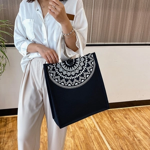 Ethnic style black canvas tote bag with white geometric print and cotton rope handles