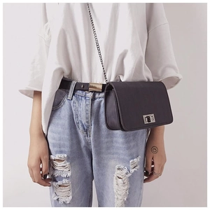 Detail of classic black square chain bag with silver twist lock worn as a waist pack