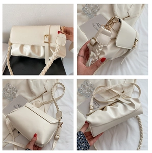 Detail view of beige ruched shoulder bag with gold hardware and dual strap options