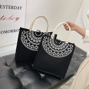 Detail of canvas tote bags with ethnic geometric patterns and woven rope handles