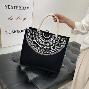 Detail of ethnic geometric print on black canvas tote bag with thick cotton rope handles