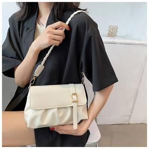 Close-up of cream white shoulder bag with pleated base and braided strap detail