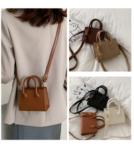 Detail showing the adjustable shoulder strap and gold hardware on a mini square bag