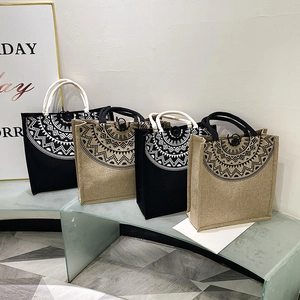 Macro detail of canvas tote bags with mandala prints and thick rope handles for storage