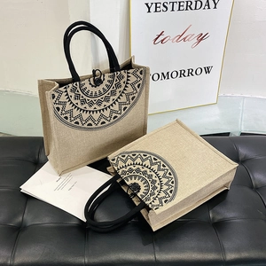 Macro view of jute tote bags with black mandala print and durable rope handles