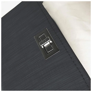 Macro shot of black epi water-ripple texture leather with silver metal twist lock buckle