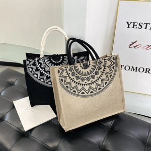 Detailed texture of canvas tote bags with mandala print and woven cotton rope handles