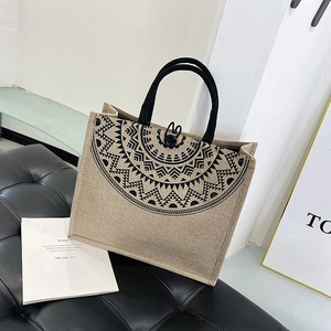 Detailed macro view of the flax canvas tote bag featuring a black mandala pattern and rope handles