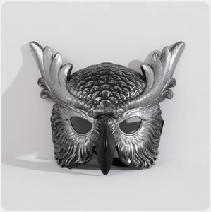 Detailed close-up of owl mask with silver feather texture and black beak for cosplay