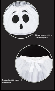 Detail of white Halloween tutu skirt showing ghost face print and satin bow decoration