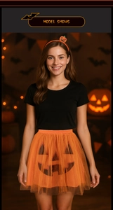 Close-up of bright orange Halloween tutu skirt with pumpkin face and glitter headband