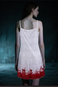 Detailed back view of a white ghost bride dress with red blood stains and damask pattern