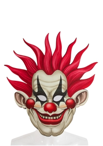 Gros plan du masque de clown en EVA avec cheveux rouges hérissés et maquillage noir des yeux
