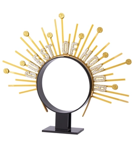Detail of GUEST OF HONOR lettering on a golden sunburst halo headband for parties