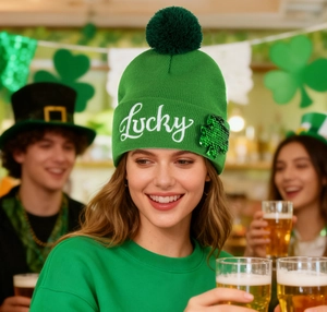 Detail of St. Patrick's Day green knit beanie with Lucky embroidery and sequin clover