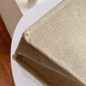 Macro shot of durable linen fabric texture with reinforced double-stitch sewing details