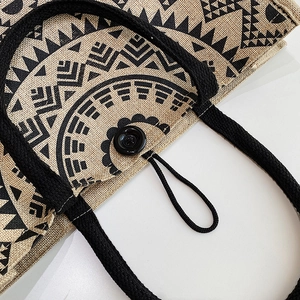 Close-up of bohemian geometric print on jute tote bag with braided rope handle