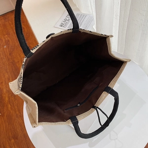 Detailed interior of large jute tote bag showing fabric lining and secure zipper pocket