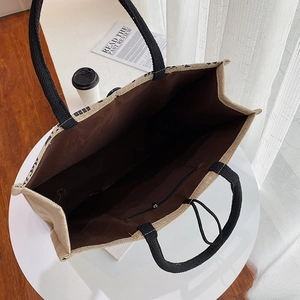 Close-up of a large jute tote bag interior featuring a sturdy zip pocket and soft lining