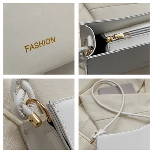 Detail showing fashion logo, smooth zipper, and metal hardware on cream leather bag