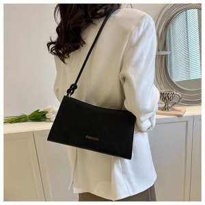 Detail of black rectangular underarm bag showing the knot strap design and fashion logo