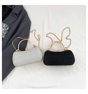 Detail of luxury glitter clutch bags with metal handles and gold chain straps