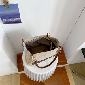 Detail view of large tote bag interior showing dark brown lining and gold hardware