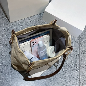 Top view of spacious beige tote bag interior showing capacity for tablets and cosmetics