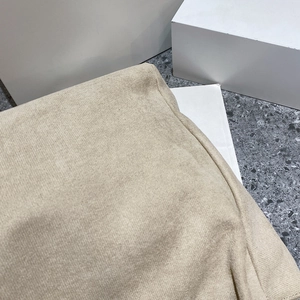 Detail of beige knit wool fabric texture on a large capacity PU leather tote bag