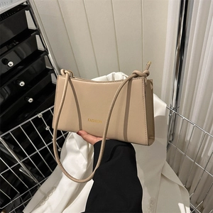 Minimalist beige leather baguette shoulder bag with gold FASHION lettering for women