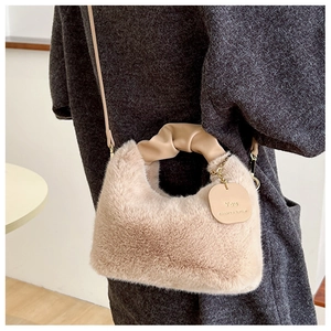 Détail du sac bandoulière en peluche beige avec texture en fausse fourrure et cuir