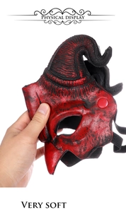 Detail of soft red and black demon mask with curved horns and realistic skin texture