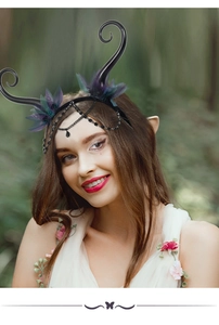 Detail of gothic fairy headband with black horns, purple mesh feathers and bead chains